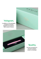 Green packaging box with a pink item inside, featuring a hologram on the lid.