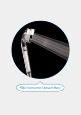 A chrome shower head spraying water, shown inside a circular black frame with the text 'Vita Puresome Shower Head' below on a light gray background.