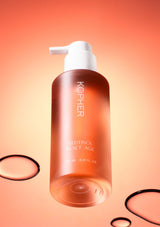 Kophier skincare bottle with pump on a peach background