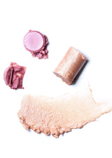 Makeup swatches of pink, beige, and brown on a white background