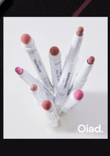 Set of makeup lip pencils with pink caps on a white background, featuring the brand 'Oiad'.