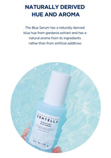 Blue serum bottle with text about naturally derived hue and aroma on a light blue background