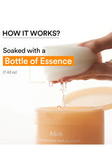A hand holds a white ceramic bowl over an open beige jar labeled 'Abib Glutathione dark spot pad' with text reading 'HOW IT WORKS? Soaked with a Bottle of Essence' on a white background.