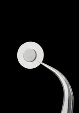 Metallic tool with a round head on a black background