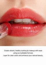 Close-up of a person applying red lipstick with a brush, text about vibrant lip makeup.