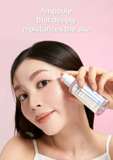 Woman applying a skincare product to her face with a pink background
