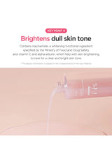 Product packaging with text on skin brightening properties on a light pink background