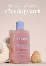 Pink bottle of flaner Snowberry Sorbet Glow Body Scrub with a strawberry on a light background