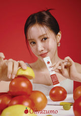 Woman holding a tube of Olivazumo product with tomatoes and other fruits on a red background