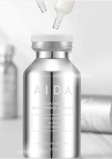 Silver AIDA skincare bottle with droppers on a light gray background
