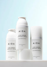 Three bottles of AIDA Ultra Barrier Ampoule Cream on a light blue background