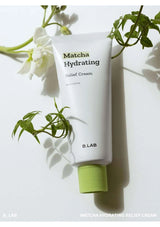 Tube of Matcha Hydrating Relief Cream with green leaves on a light background