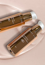 Two OFU TOFU TONE hair toners on a light pink background