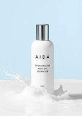 AIDA Glutathione Milk Oil Cleanser bottle with a light blue background