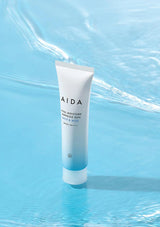 AIDA skincare tube on a blue water background