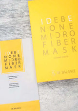 Yellow IDEBE NONE MICRO FIBER MASK packaging on a gray surface