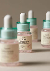 Skincare dropper bottles with visible branding on a neutral background
