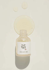 Skincare bottle with a label on a light beige background