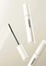 Two white cosmetic tubes with black labels on a light beige background