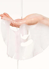 Clear gelatinous material being stretched between two hands on a white background