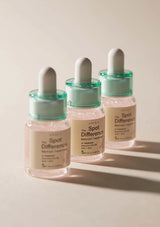 Three skincare dropper bottles labeled 'The Spot Difference' on a neutral background