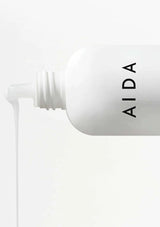 White bottle with 'AIDA' branding on a white background