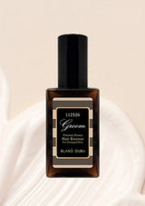 Bottle of Groom hair essence on a white background