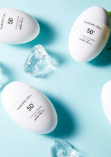 White sunscreen bottles with 'N:Born Cell' branding on a light blue background