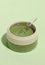 Jar of Avocado Butter Tart Pack Cleanser with a spoon on a green background