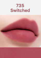 Lipstick shade 735 'Switched' applied on a lip with a white background