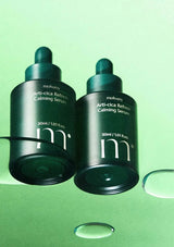 Two bottles of moiyanny Anti-Cica Refine Calming Serum on a green background