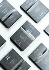 Multiple boxes of a skincare product with visible branding on a light background