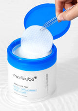Medicube Zero Pore Pad with a hand using a applicator on a white background