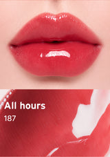 Close-up of glossy red lips with 'All hours 187' text on a maroon background
