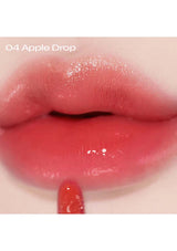 Close-up of lips wearing a glossy red lipstick labeled '04 Apple Drop'.