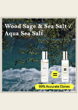 Two perfume bottles labeled 'Wood Sage & Sea Salt' with a scenic background.