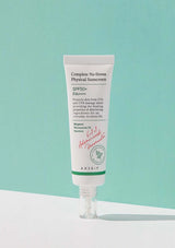 Tube of AXIS-Y Complete No-Stress Physical Sunscreen on a light blue background