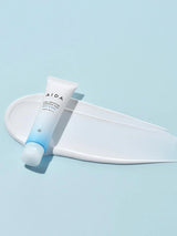 AIDA skincare product on a white tray with a light blue background