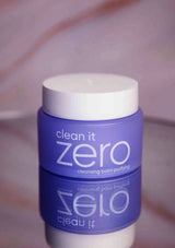 Blue and white container labeled 'clean it zero' on a pink background