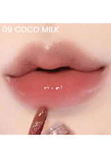 Close-up of a lip with a glossy lip product labeled '09 Coco Milk'.