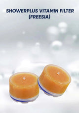 Two orange shower filters labeled 'Showerplus Vitamin Filter (Freesia)' on a white background.