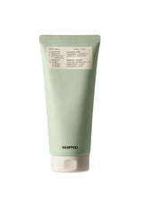 Green tube of whipped product with a label on a white background