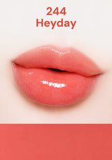Close-up of glossy pink lips with '244 Heyday' text on a white background