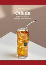 Glass of iced tea with a metal straw on a white surface, featuring the Odada brand.
