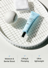 Skincare tube on a metallic surface with towel and cotton ball, featuring text on benefits.