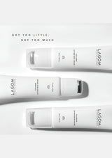 Three white skincare bottles with 'LAGOM' branding on a light gray background.