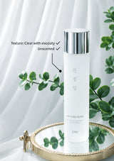 Skincare bottle with text indicating texture, viscosity, and scent on a white background with green leaves.