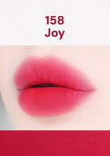 Lipstick swatch labeled '158 Joy' on a white background