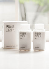 Two bottles and a box of skincare product on a white background