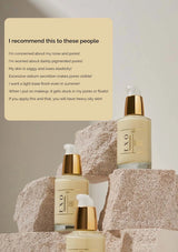 Skincare bottles with text on a stone surface